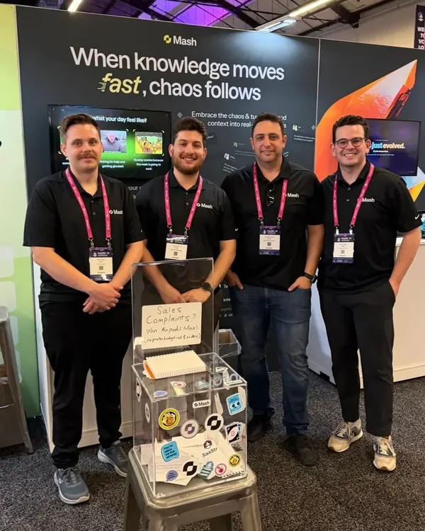 Four team members at the Mash booth at SaaStr